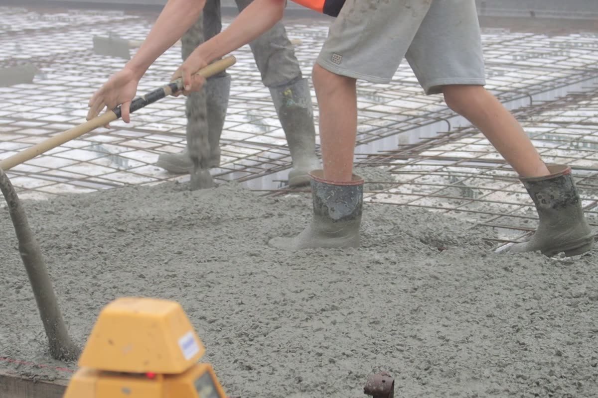 Concrete being poured and spread